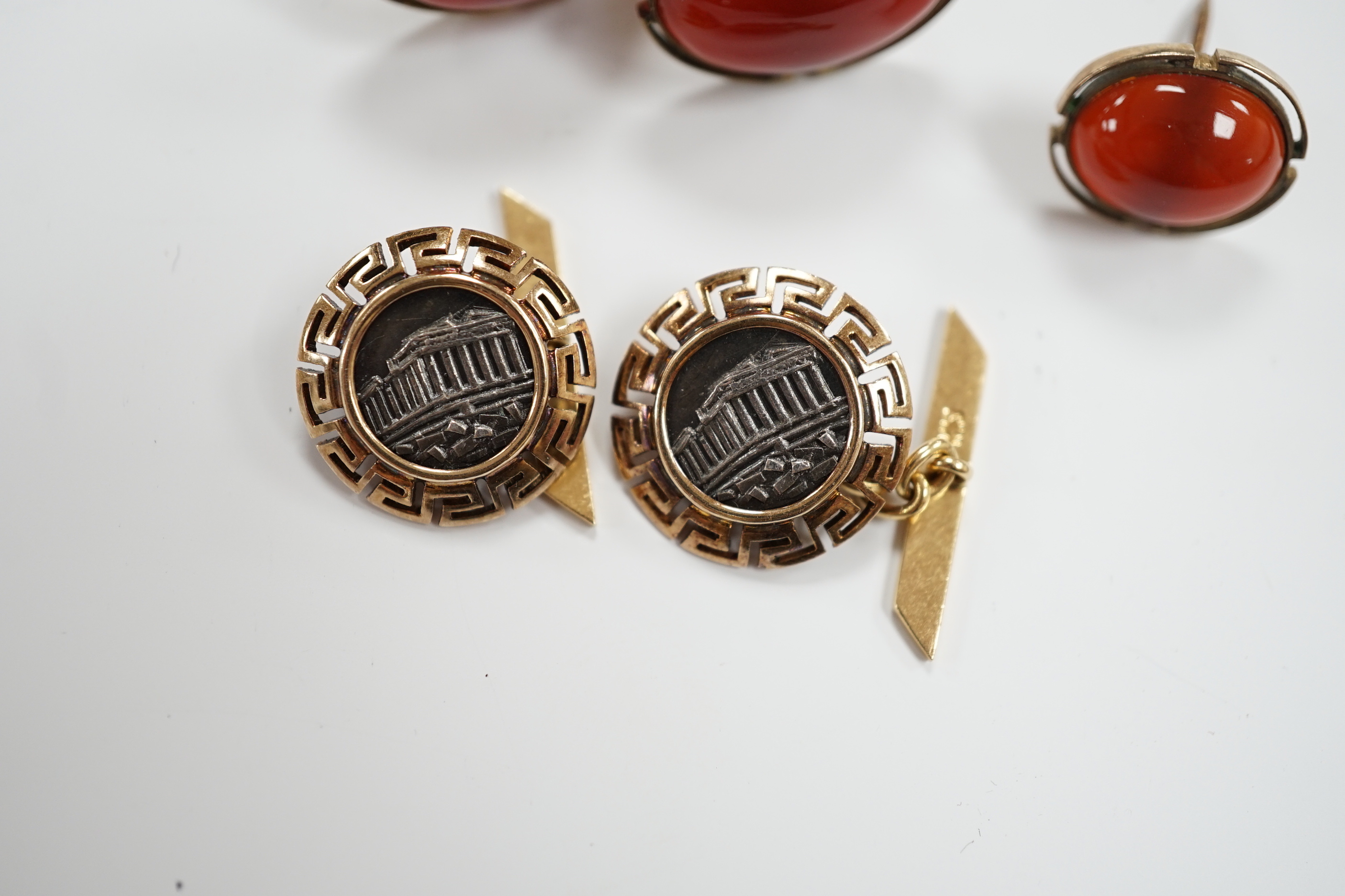 A pair of 18k and white metal 'Parthenon' circular cufflinks, with Greek Key border, 17mm, gross 8.9 grams, a pair of 10k and cabochon cufflinks and an earring.